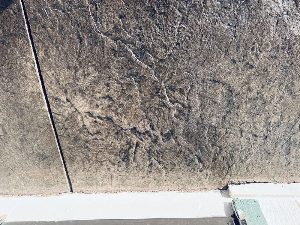 Textured surface of a weathered stone wall, showcasing intricate patterns and natural aging.